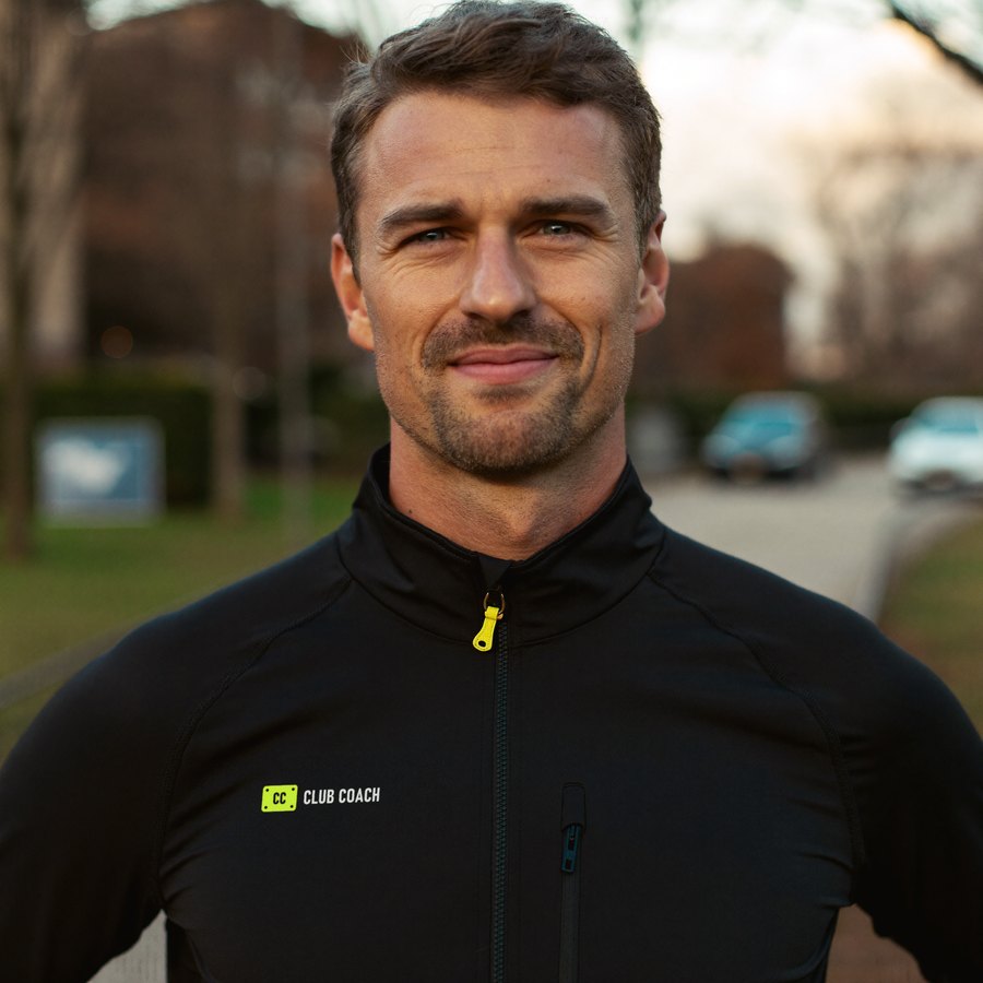The Club Coach coach in a black Club Coach running jacket